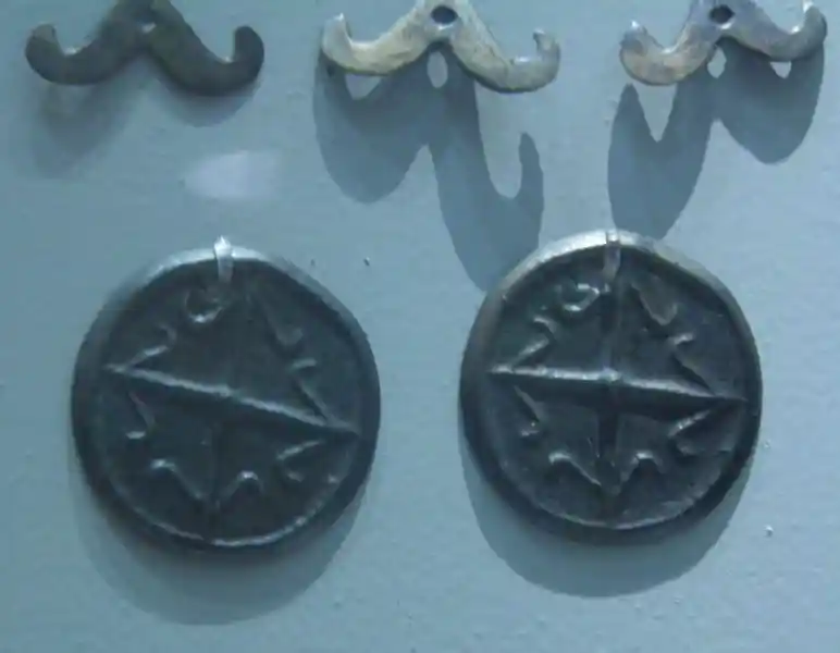 Bronze solar disc with cross in the center